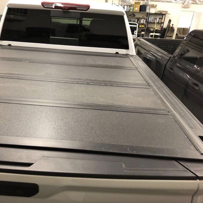 Hard tonneau cover with rack
